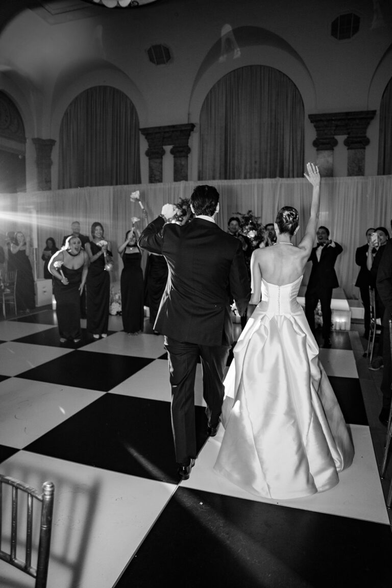 black and white photo of bride entering the dance floor during their reception
