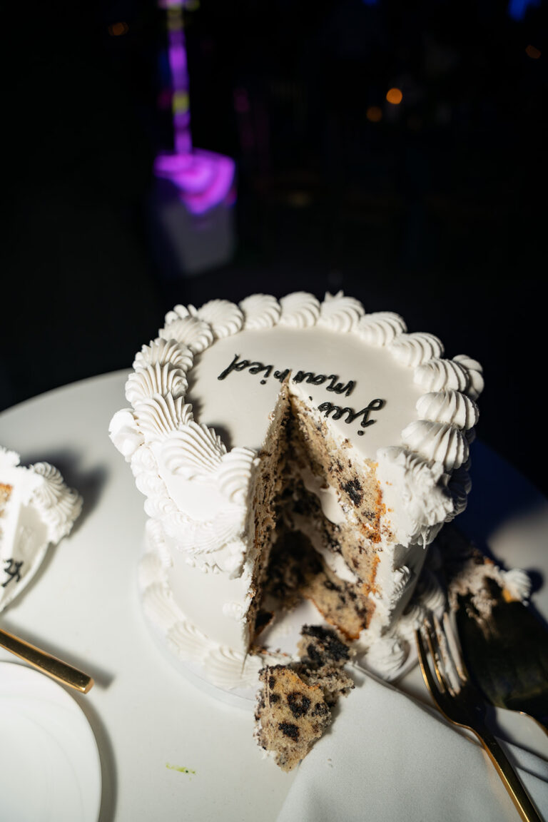 Sliced wedding cake shot in editorial flash style
